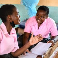 Two school students chatting and smiling